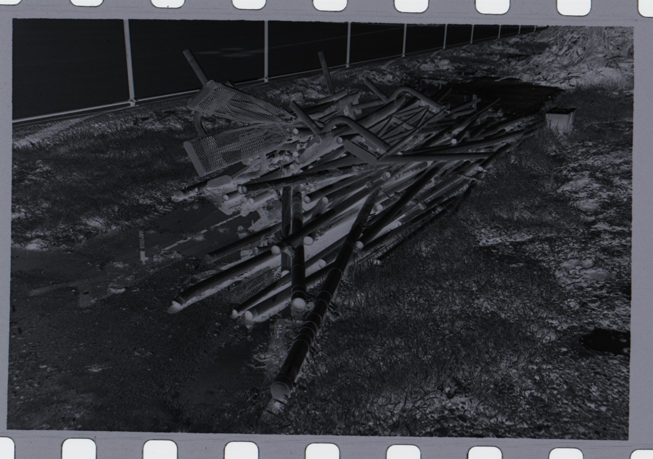 Raw scan of a 35 mm negative, uninverted and uncorrected: a pale, low-contrast frame with the sprocket holes of the film visible along the top and bottom edges.